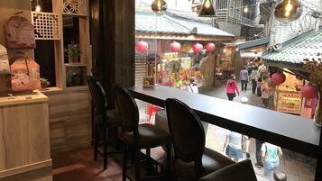 Un restaurante con vistas a un mercado callejero animado.