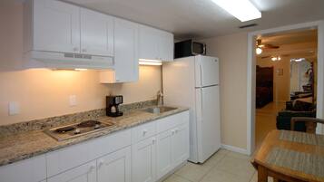 Cottage 1A, Studio | Private kitchen | Full-sized fridge, microwave, stovetop, coffee/tea maker