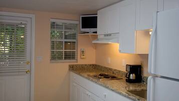 Cottage 1A, Studio | Private kitchen | Full-size fridge, microwave, stovetop, coffee/tea maker