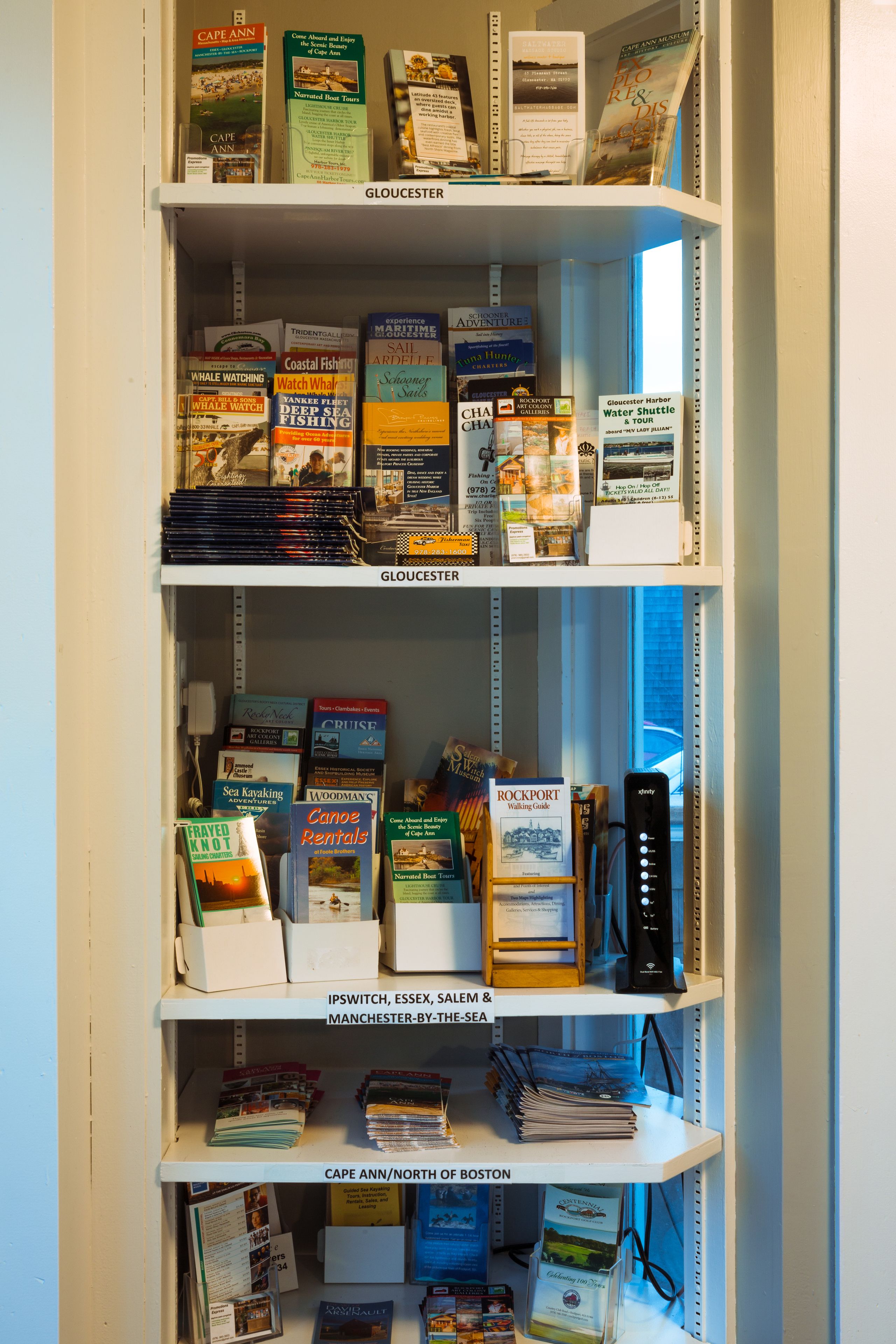 A bookshelf with travel books and maps, organized by destination.