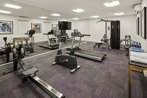 A gym with treadmills, stationary bikes, and weight machines. - Quest East Perth (East Perth)