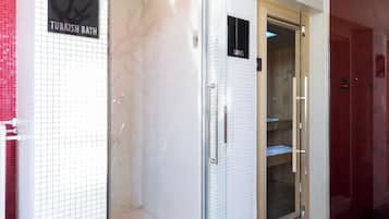 Experience the sleek lobby with a Turkish bath, wooden bench, and polished floors.