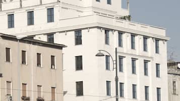Stylish building with a grid-patterned facade and a prominent upper-level structure.