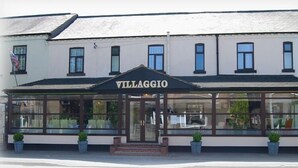 A two-story building with a sign reading "VILLAGGIO" above the entrance. - Villaggio Hotel & Restaurant (Warrington)