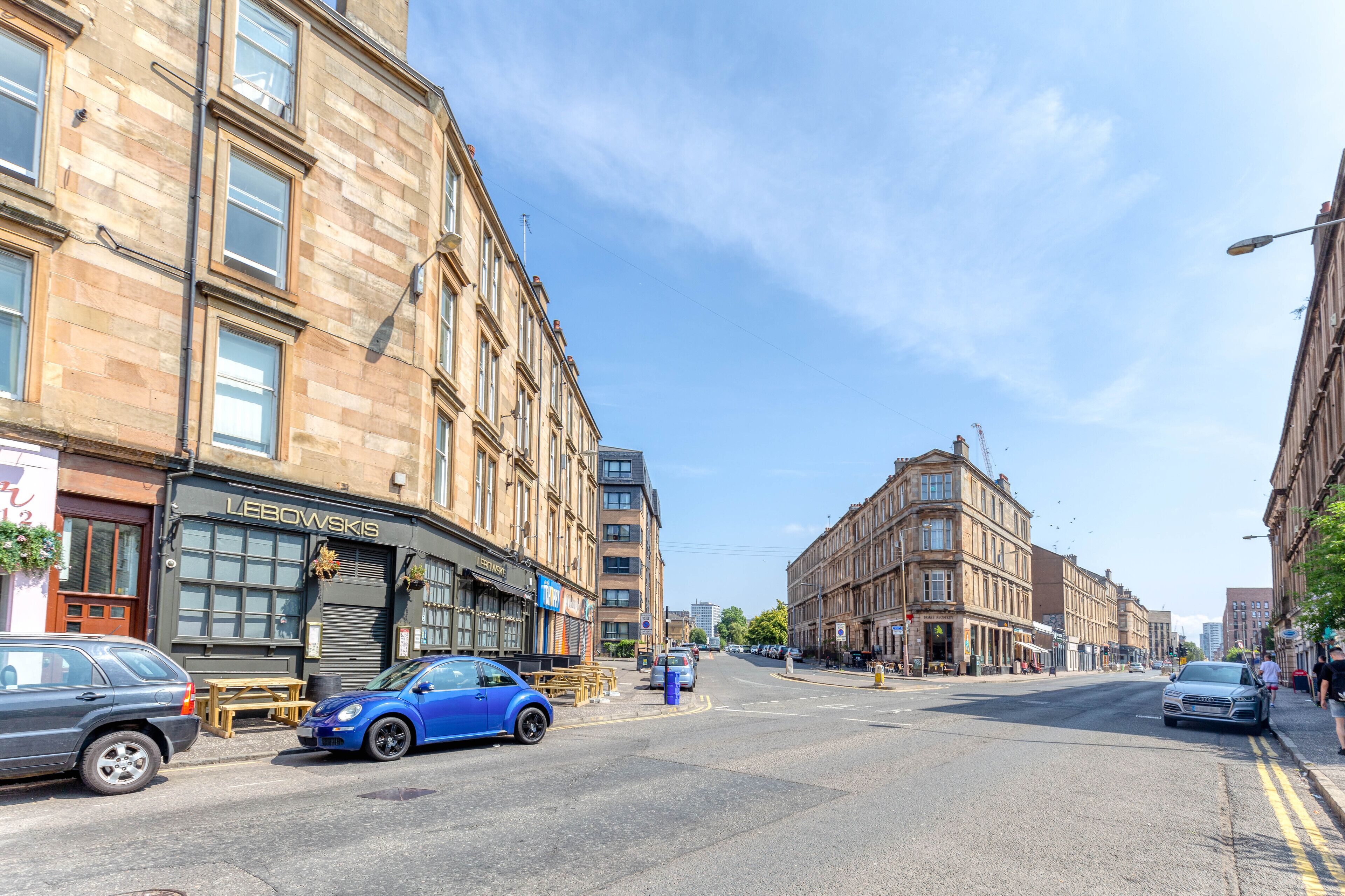 A street view with a building labeled "LEBOWSKIS" on the left.