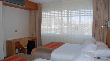 Twin Room, Partial Ocean View | Minibar, in-room safe, desk, blackout curtains