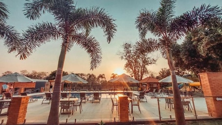 Indoor pool, outdoor pool, open 10:00 AM to 10:00 PM, pool umbrellas. Cataratas Park Hotel e Eventos