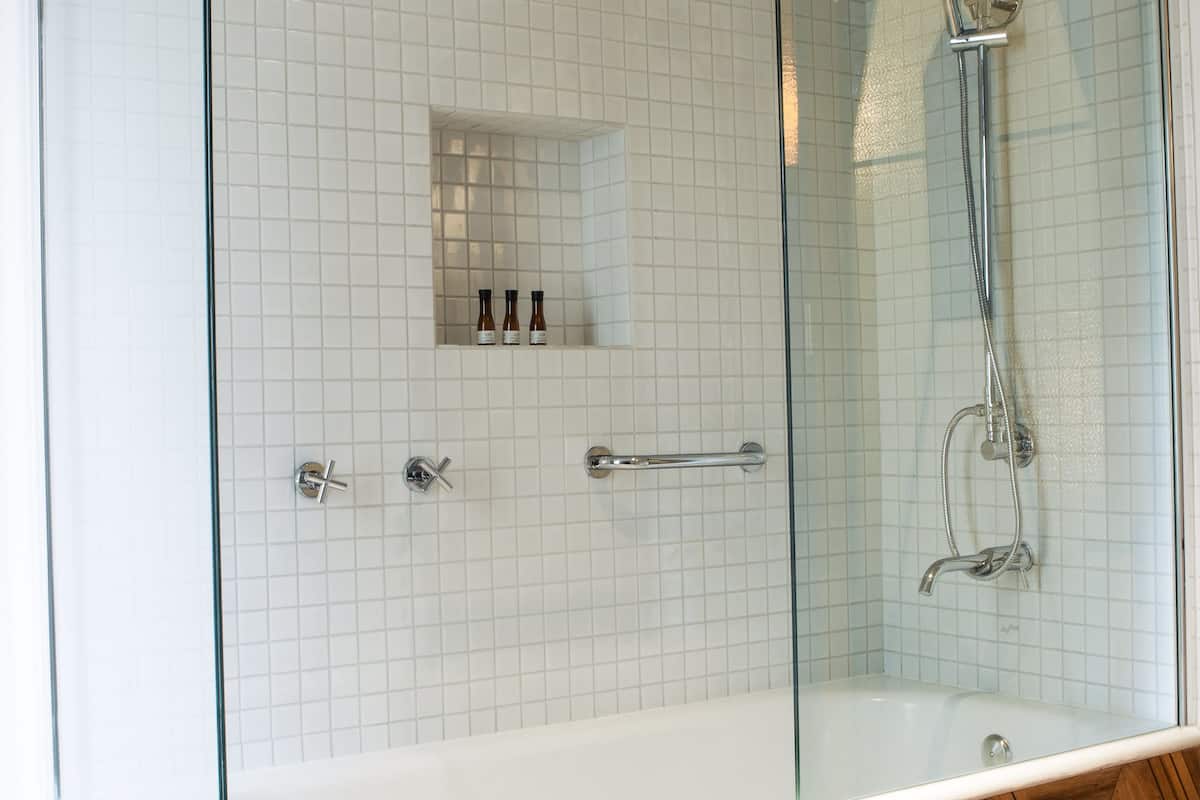 deluxe double room | bathroom | rainfall showerhead, designer toiletries, hair dryer, bathrobes