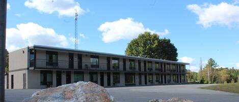 A modern building with a flat roof and large windows.