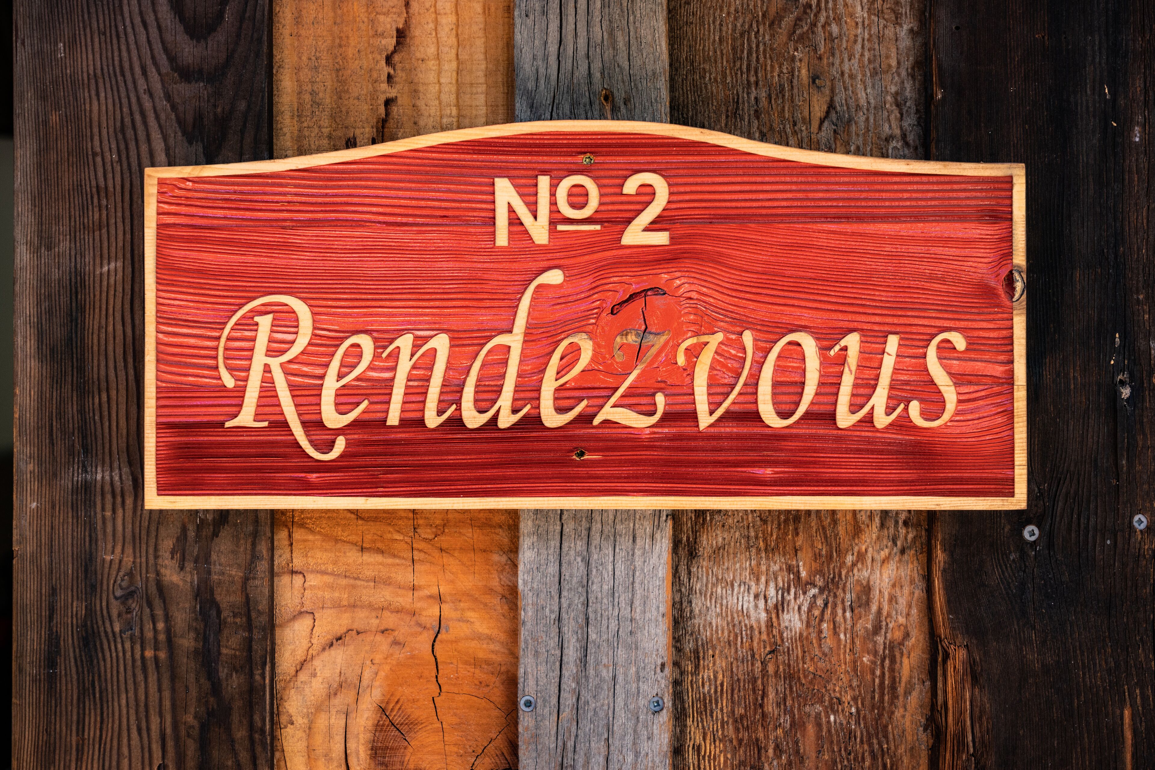 A wooden sign with "No 2" and "Rendezvous" written on it.