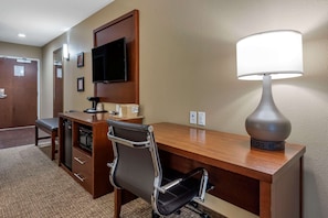 Work in comfort with a desk, flat-screen TV, and comfortable chair.