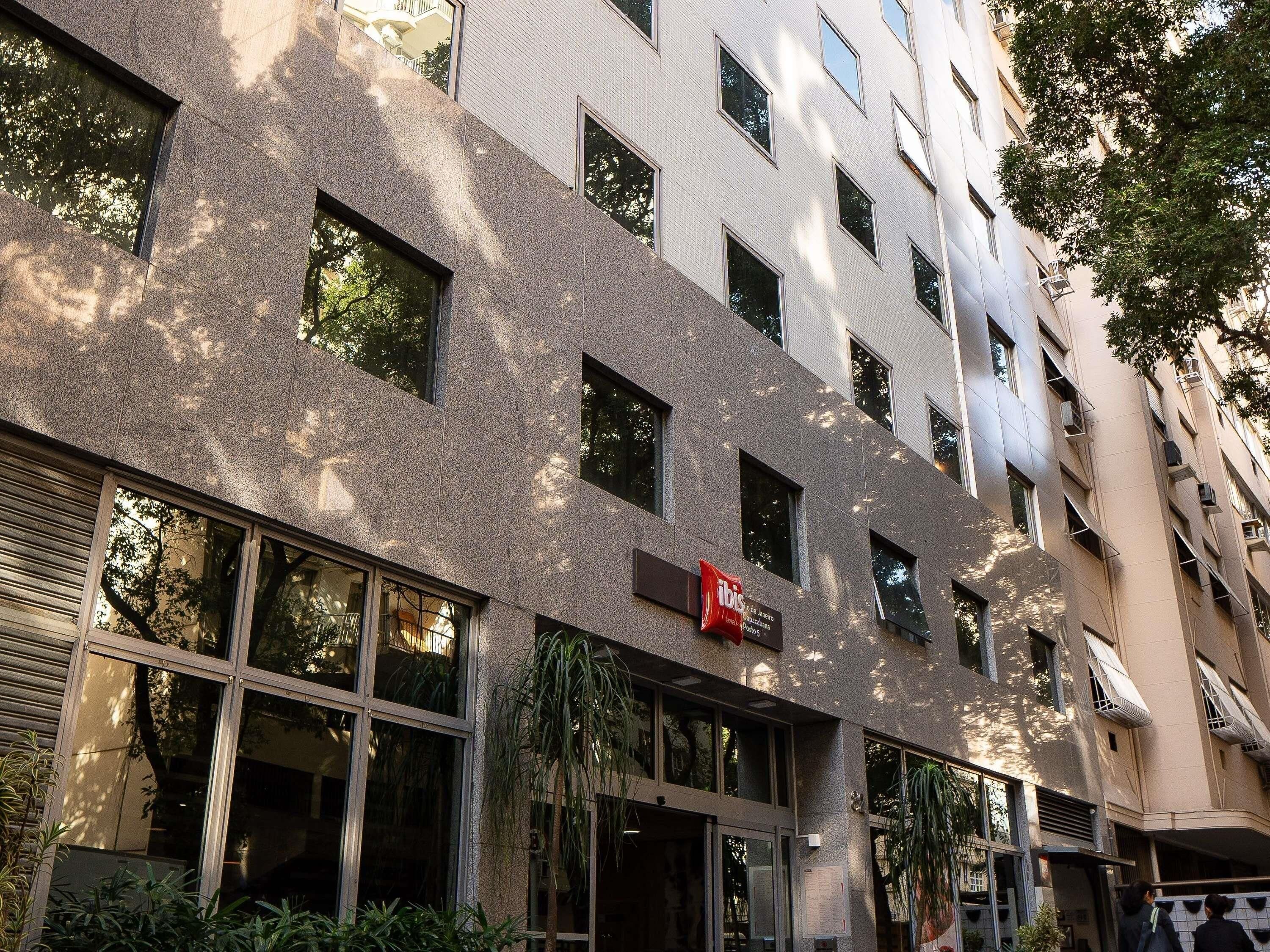 A multi-story building with a modern facade, large windows, and a visible entrance.