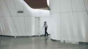 A modern interior with a person cleaning.