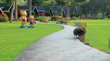 Stroll through the tranquil gardens, lined with traditional buildings and lush greenery.