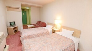 A hotel room with two beds, a desk with a computer, a lamp, and a green door in the background. - Hotel Listel Inawashiro Main (Inawashiro)