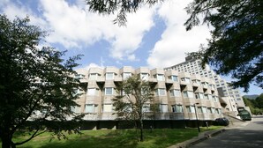 A modern building with a unique architectural design, featuring a series of balconies and large windows. - Hotel Listel Inawashiro Main (Inawashiro)