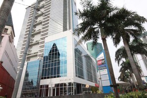 A modern building with a glass facade, a prominent 'ATU Center' sign, and surrounding palm trees.