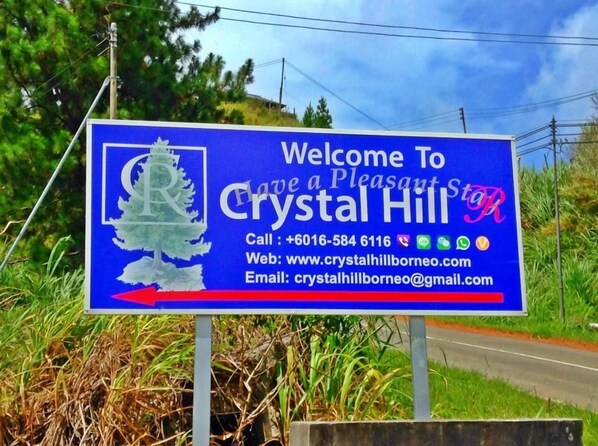 A welcome sign for Crystal Hill with contact information.
