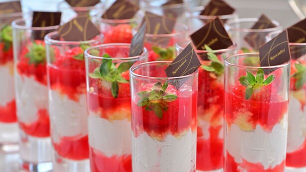 A row of clear glasses filled with layered dessert, garnished with mint leaves and chocolate pieces. - Hotel Listel Inawashiro Wing Tower (Inawashiro)