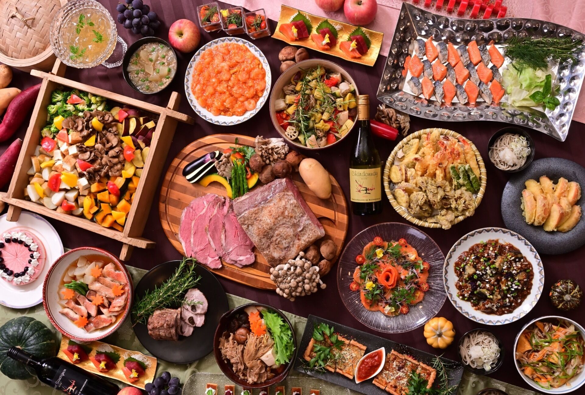 A variety of dishes and food items on a table, including seafood, meats, and vegetables, suggesting a buffet or meal setting.