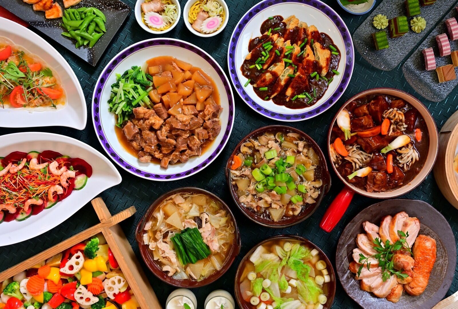 A variety of dishes, including soups, noodles, and stir-fries, arranged on a table.