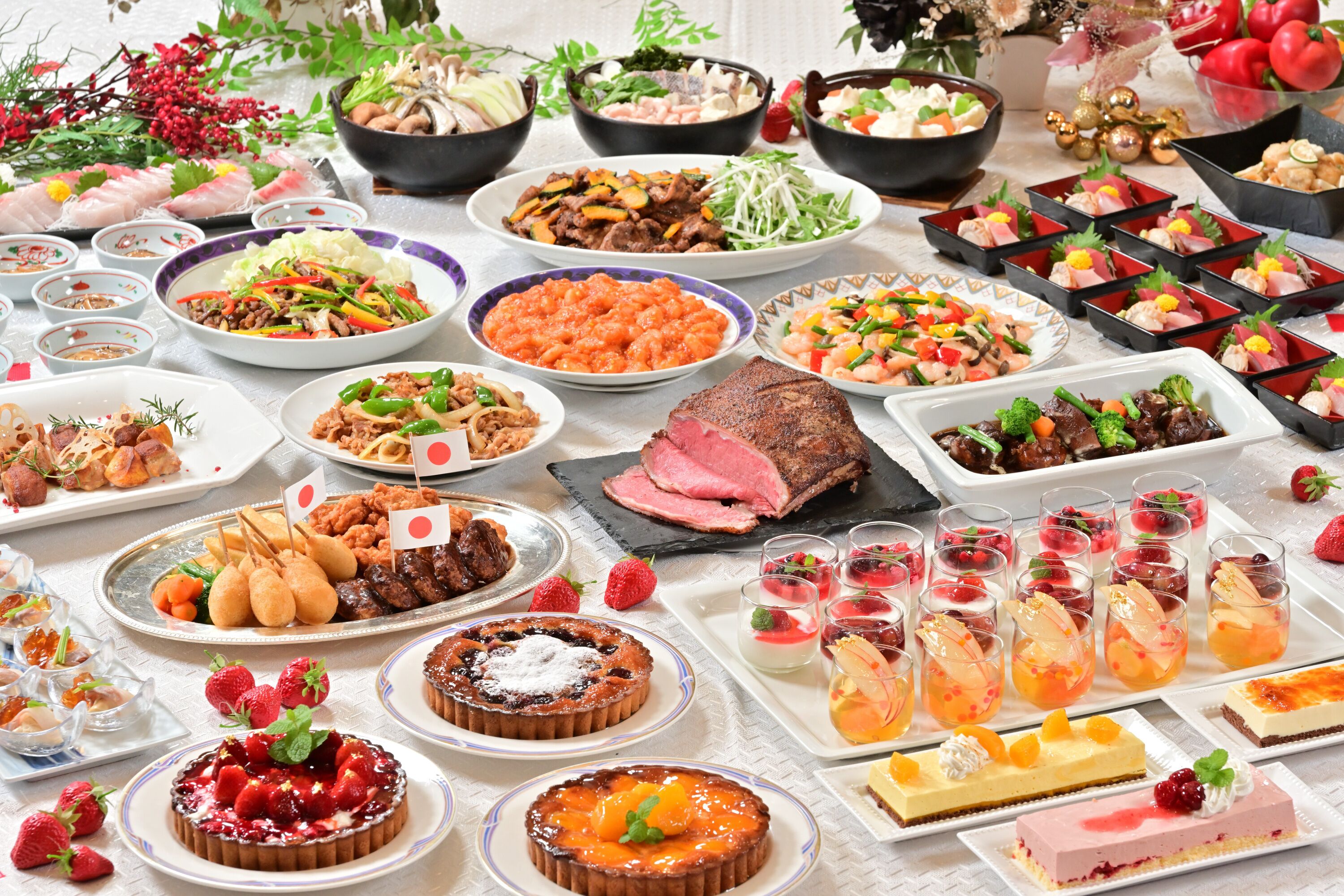 A variety of dishes and desserts on a table, including sushi, salads, and fruit tarts.