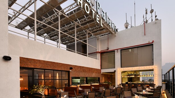 A rooftop bar area with outdoor seating and a bar. - Krishna Palace Hotel Ambernath (Ambernath)