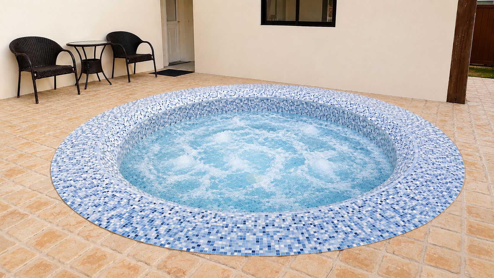 A hot tub with a mosaic tile border, surrounded by a tiled patio area.