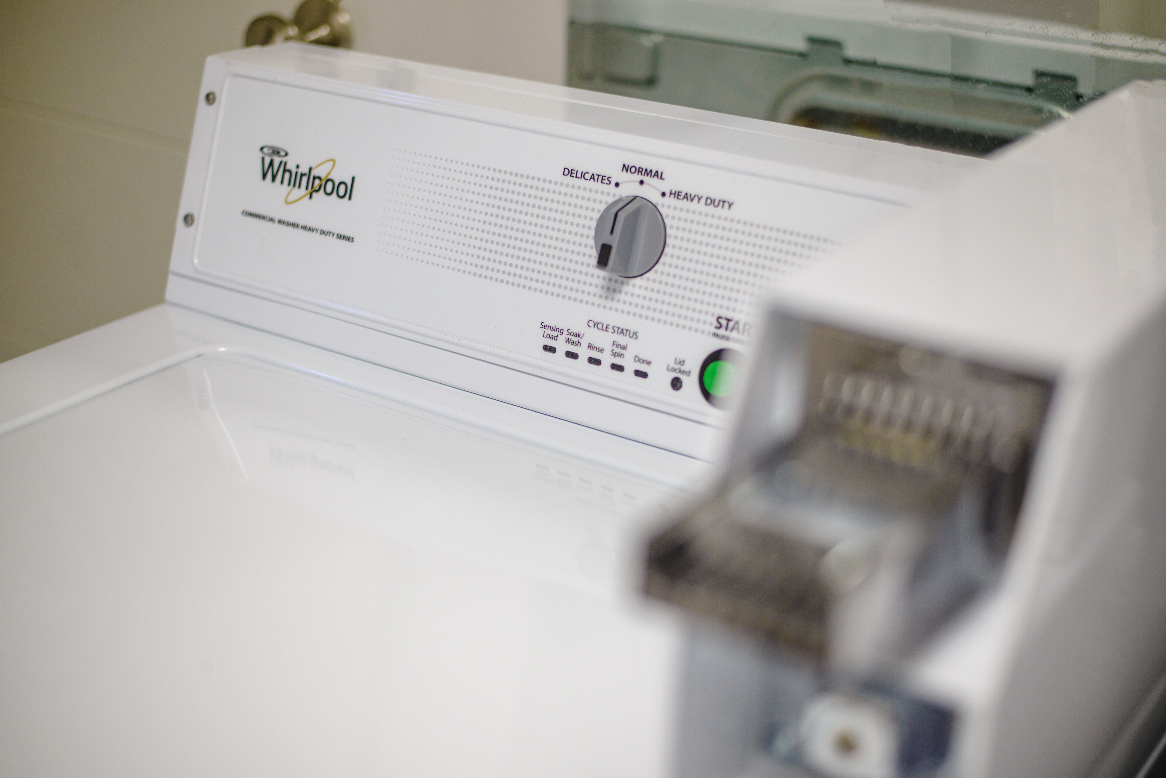 A Whirlpool washing machine with a control panel displaying various settings.