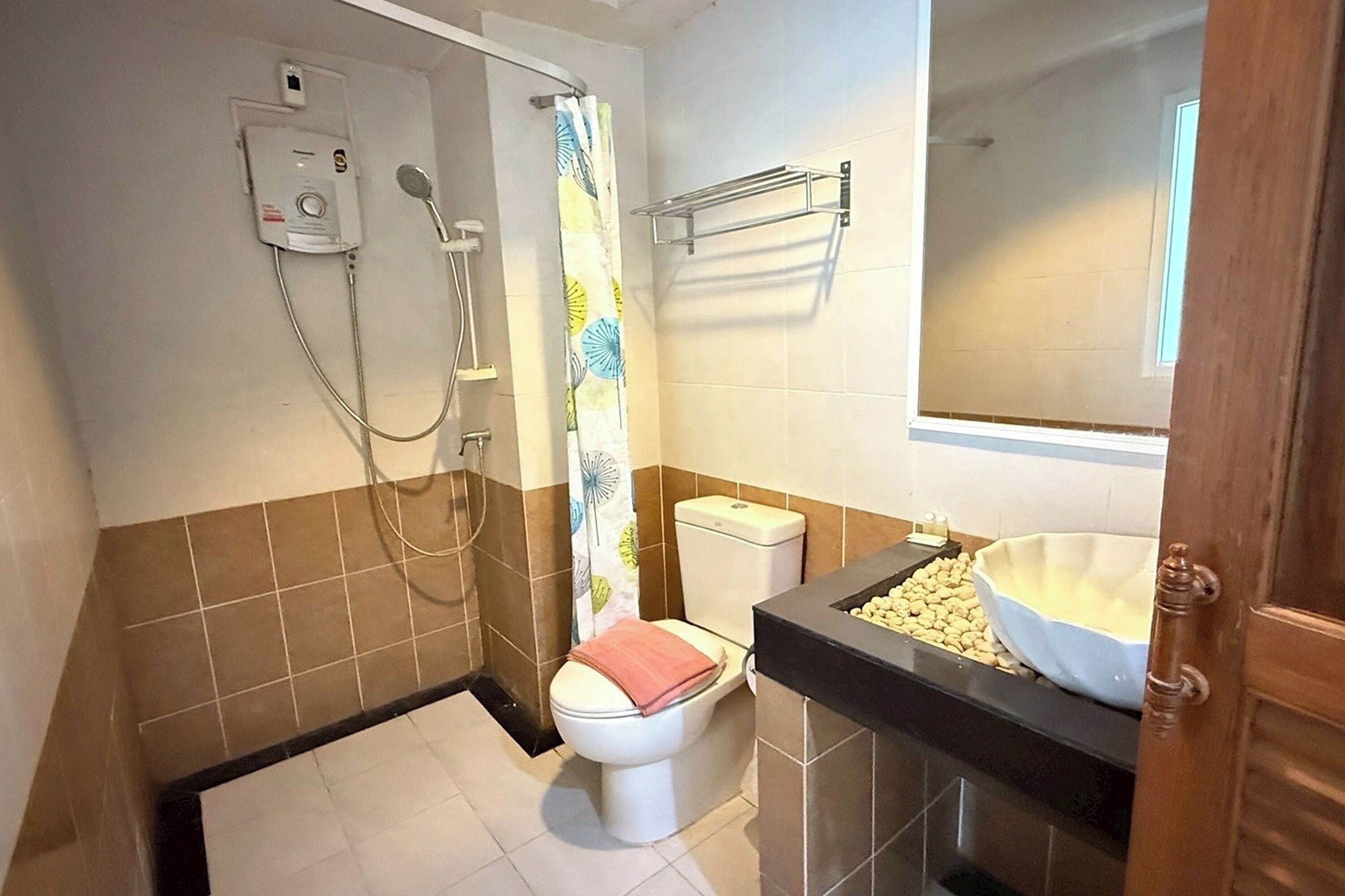 Un baño con inodoro, ducha y lavamanos.