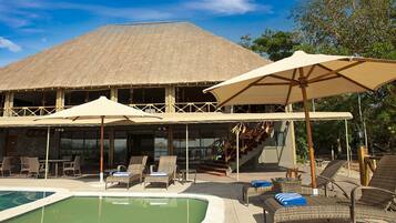 Outdoor pool, open 7 AM to 6 PM, pool umbrellas