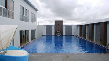 A swimming pool with a modern building in the background.