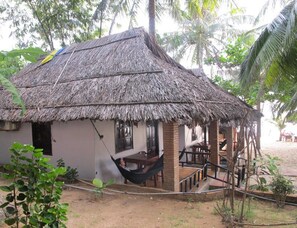 A thatched-roof hut with a porch and a hammock. - Nhat Lan Resort (Phu Quoc)