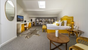 A bedroom with a bed, bedside table, lamp, and a desk with a chair. - Hôtel Le Y Saint-Tropez (Saint-Tropez)