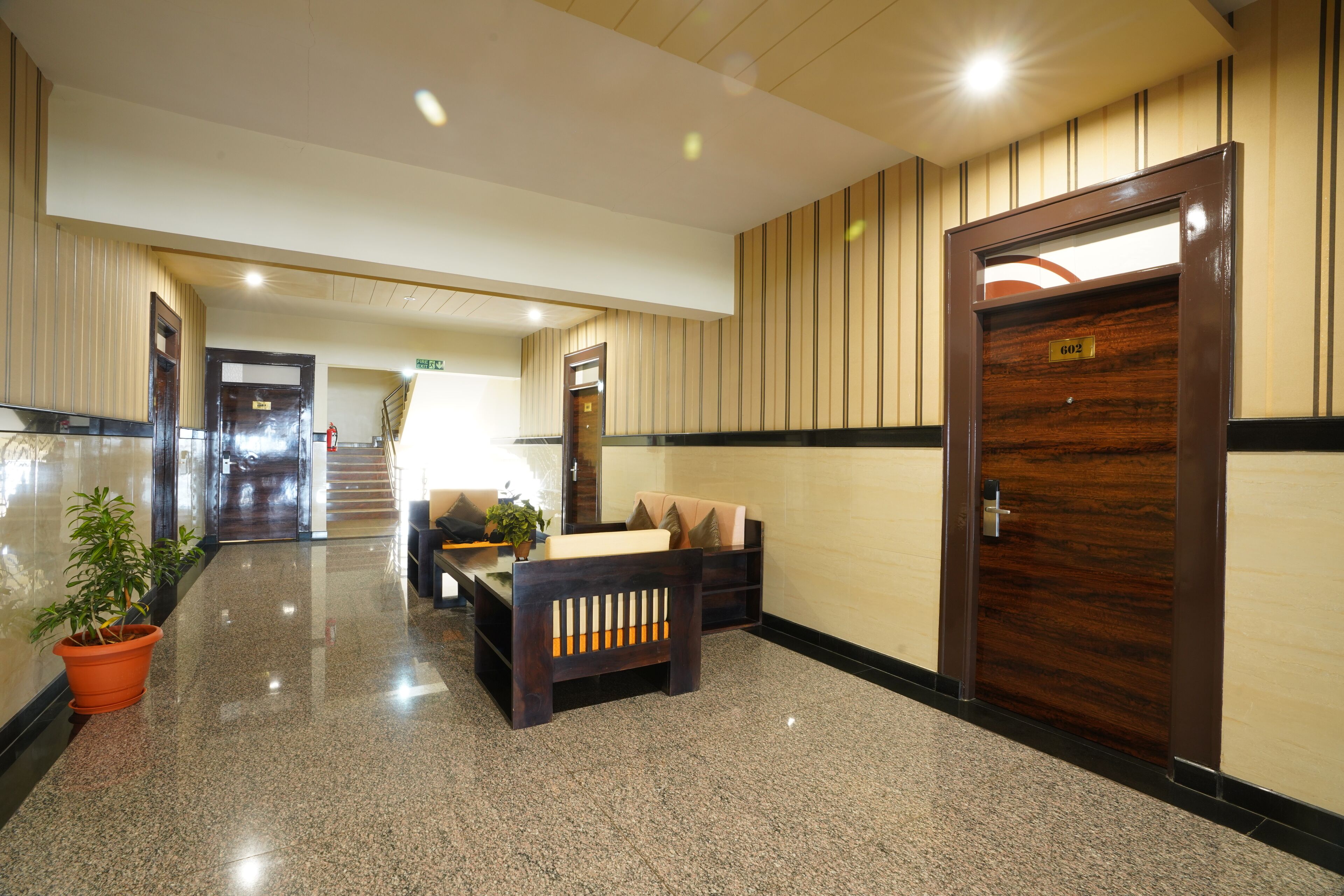 A lobby with a reception desk, seating area, and a door marked '602'.