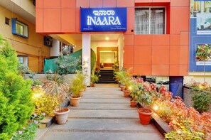 A hotel entrance with a sign reading "INARA" and a staircase leading to the entrance. - Hotel Vista Suites, Bangalore (Bengaluru)