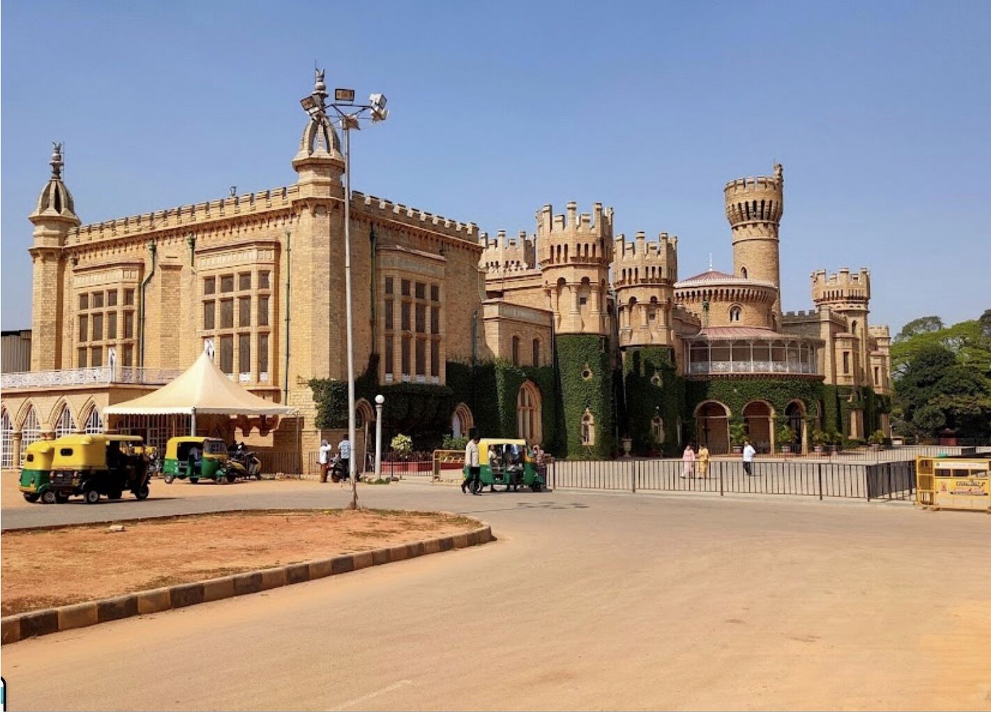 A large, historic building with a prominent tower and castle-like architecture.