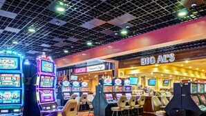 A casino with multiple slot machines and a bar area. - Mountaineer Casino Resort (New Cumberland)