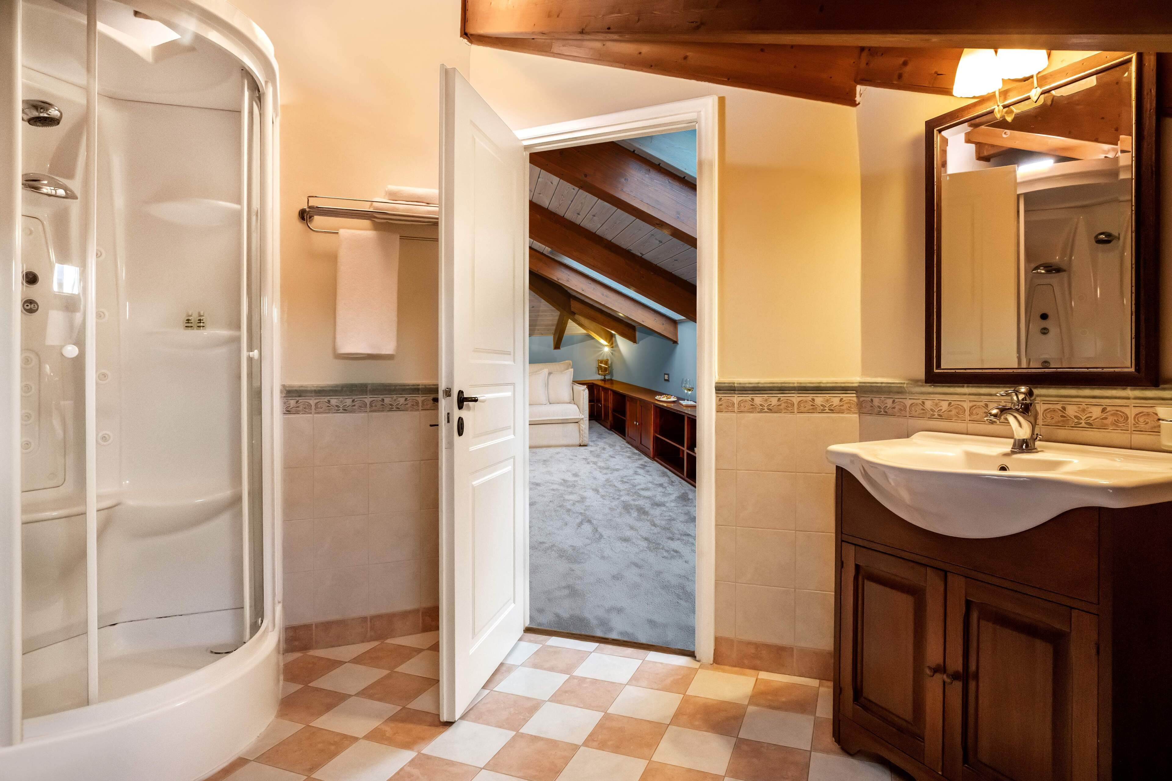 A bathroom with a shower, a sink, and a mirror.
