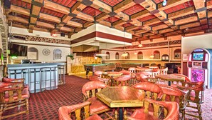 A spacious indoor area with multiple seating arrangements, a pool table, and a bar area. - Hotel Motel Penn - Mass (Trois-Rivieres)
