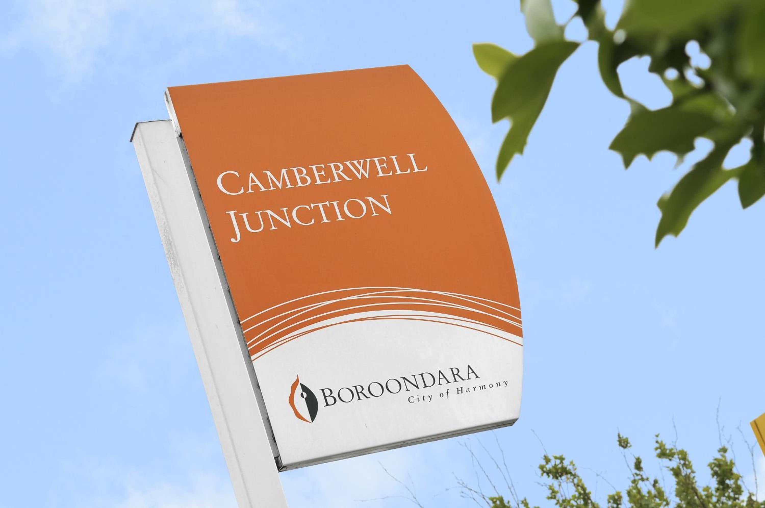 A sign for Camberwell Junction with the Borondara City of Harmony logo.