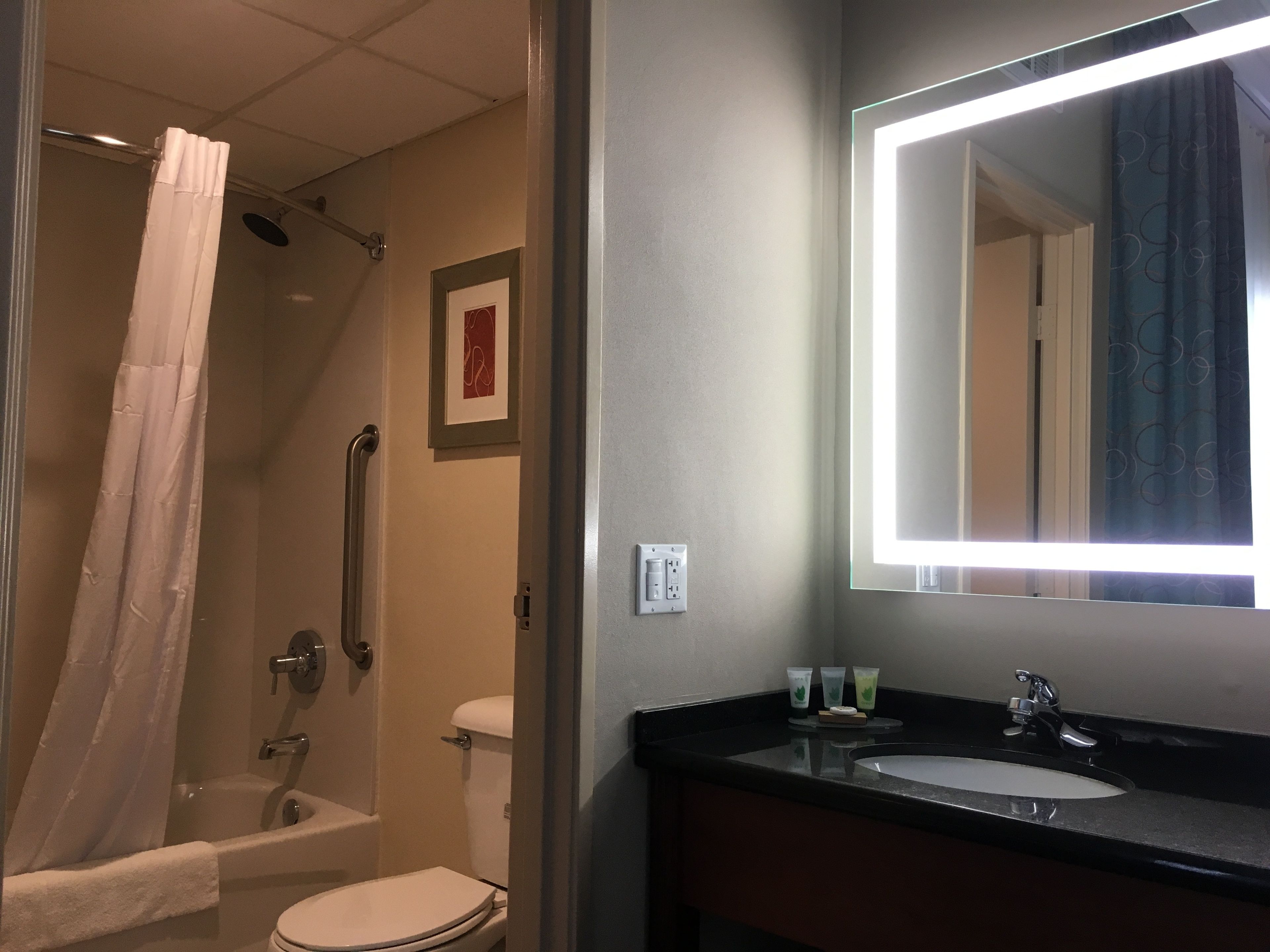 A bathroom with a bathtub, toilet, and sink.
