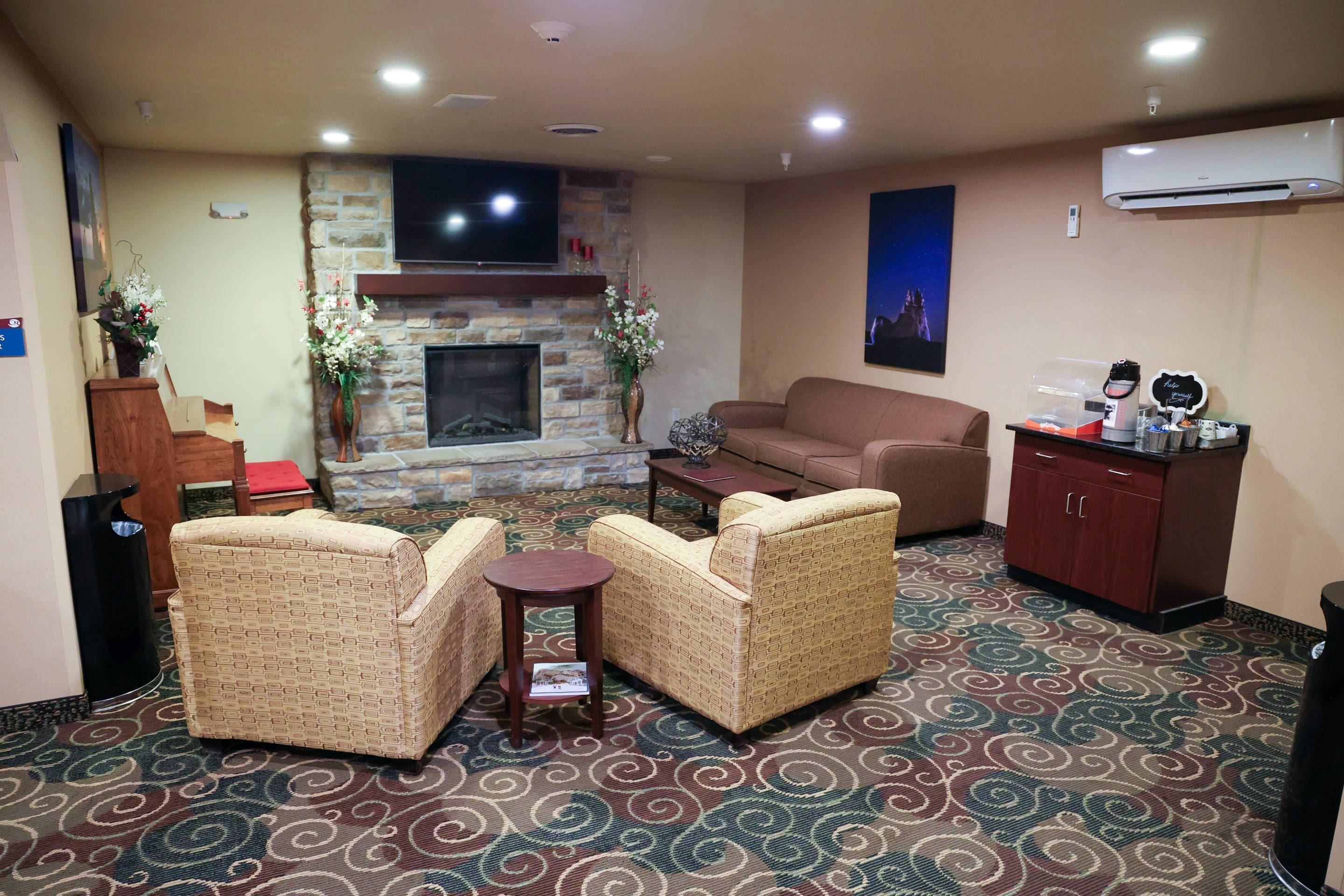 A living room with a fireplace, patterned carpet, and a sofa.