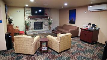 A living room with a fireplace, patterned carpet, and a sofa.