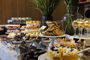 A buffet with various desserts and drinks.