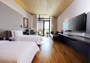 A hotel room with two beds, a desk, a TV, and a view of the outdoors. - Midori Clark Hotel and Casino (Mabalacat City)