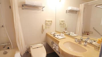 A bathroom with a toilet, sink, and mirror. There are towel racks and a shower curtain.