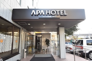 The entrance of APA HOTEL with a modern facade, glass doors, and a visible indoor plant. - Apa Hotel Saitama Shintoshin StationKita (Saitama)