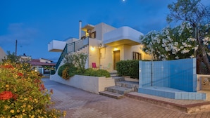 A modern two-story house with a balcony, a staircase, and a small garden area. - Bellino Apartments - Adults Only (Hersonissos)