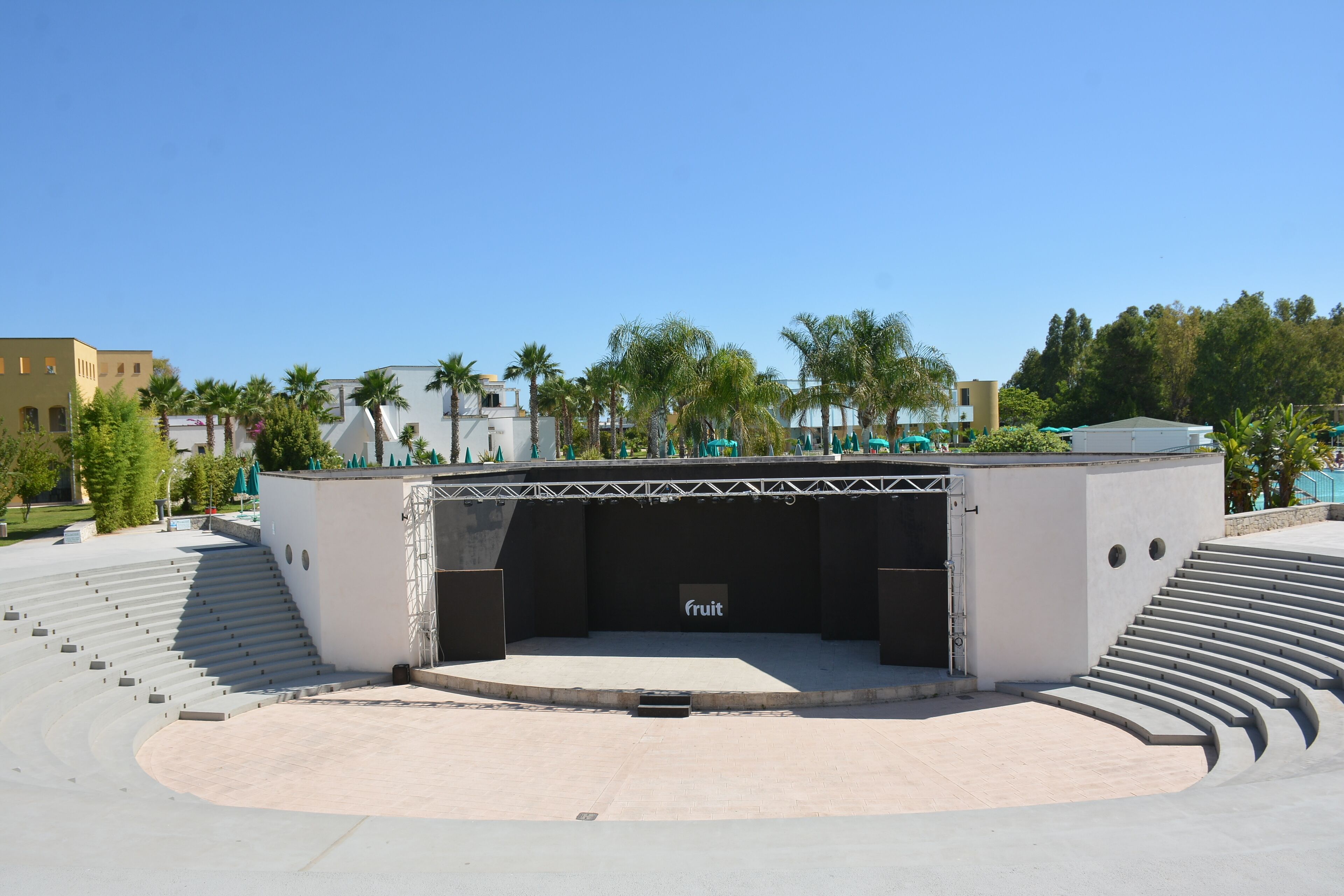 An outdoor amphitheater with a stage labeled "fruit" and a curved seating arrangement.